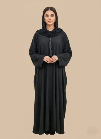 Neutral woman abaya in soft crepe, open-front kimono sweater style, side pockets and belt shown on model against light studio backdrop