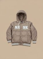 Tan hooded puffer jacket for boys with white "NE SK" lettering on the front, ribbed striped cuffs, and a button closure.