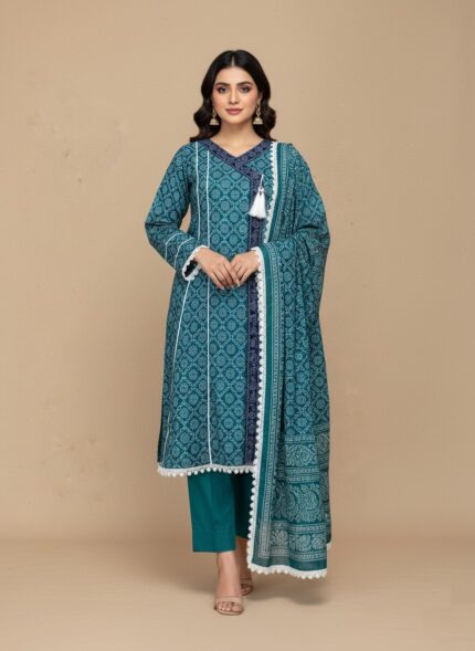 A woman wearing a vibrant teal printed khaddar Angrakha style suit with a long-sleeved shirt, matching trousers, and a coordinating printed khaddar dupatta. The suit features geometric prints, white lace trim, and a tassel.