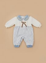 Cute baby romper with white knit upper, blue plaid lower, blue crochet collar, lace, and brown bow.