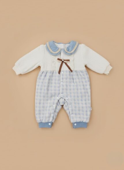 Cute baby romper with white knit upper, blue plaid lower, blue crochet collar, lace, and brown bow.