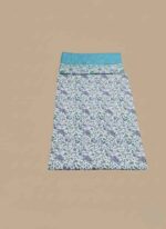Two folded pieces of 3 PC unstitched lawn fabric, one with a blue base and floral border, and the other with a white base and purple and green floral print.