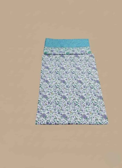 Two folded pieces of 3 PC unstitched lawn fabric, one with a blue base and floral border, and the other with a white base and purple and green floral print.