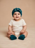 Velvet baby cap and booties set with flower design in red and teal blue for newborns and infants.