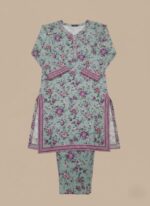 Half-length image of a woman wearing a light green Women's Floral Tunic with an all-over purple floral print, an embroidered V-neckline, and long sleeves with patterned cuffs.