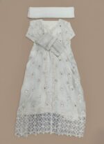 Women's embellished maxi dress with intricate silver detailing and a long, flowing design, folded on a light background.