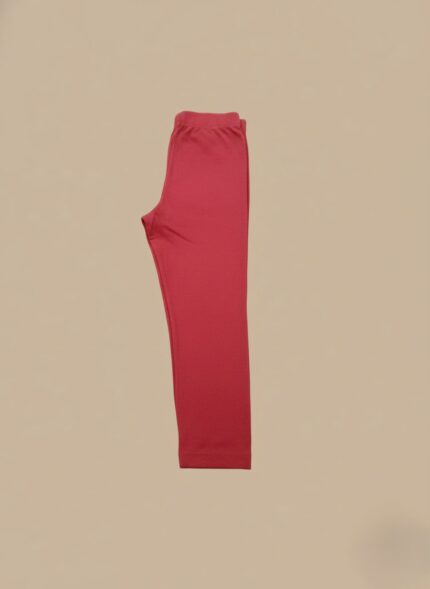 Folded red leggings made from soft cotton, ideal for women seeking comfortable and stylish everyday wear.