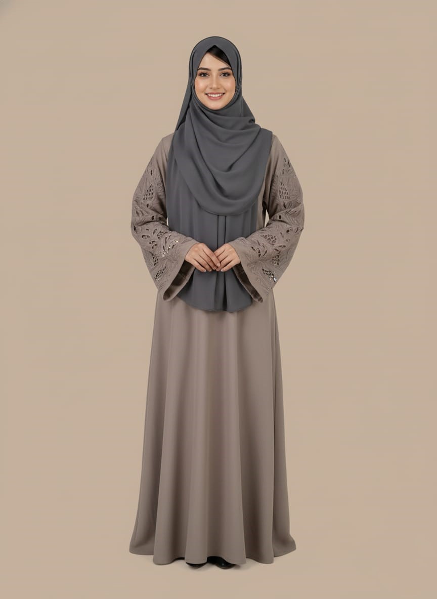 abaya dress with intricate cut-out lace sleeves Chic taupe abaya dress with intricate cut-out lace sleeves and a grey hijab, modeled by a smiling woman. A sophisticated modest fashion sweater.