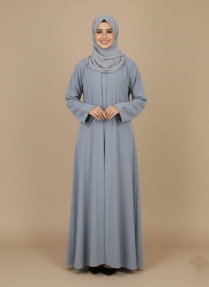 Classic grey simple abaya design with a subtle pleated front, modeled by a smiling woman. A comfortable and elegant modest Islamic sweater.