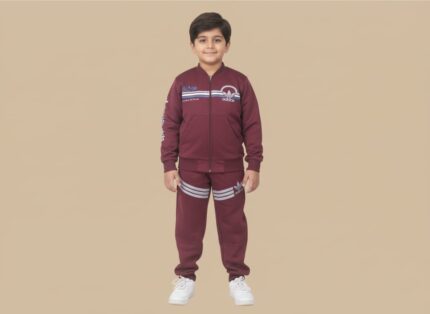Happy boy in a maroon sports tracksuit with a zip-up jacket and striped joggers, featuring sports branding