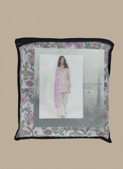 Full-length image of a smiling woman wearing a light pink Women's Floral Suit with a floral printed tunic, patterned trousers, and a pink and white striped dupatta, standing against a beige background.