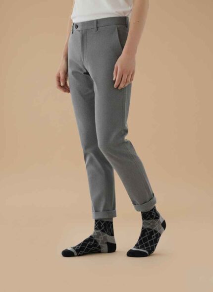 Main Image: Pair of Gelani's woolen winter socks in dark packaging on a blue background. Detail Shot: Close-up of black woolen texture and stitching pattern on men's winter socks. Packaging Shot: Two packs of Bodymax and Gelani style winter socks showing labels and branding. Angle View: Side view of folded black winter socks showing thickness and fabric quality. Lifestyle/Flatlay: Flat lay of men's dark colored socks ready for winter wear. Black Socks for Men