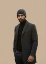 Front view of Gelani's gray wool cap for men on a light brown background. Close-up of the knitted wool texture on a gray winter beanie for men. Stylish gray stitched cap for men showing the brand logo detail. Men's winter fashion accessory gray wool beanie for the Pakistani climate. Gelani's premium gray cap for men displayed as a flat lay winter essential. gray cap for men