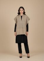 Beige women sweater shawl worn over black dress, sleeveless knit wrap for winter layering.