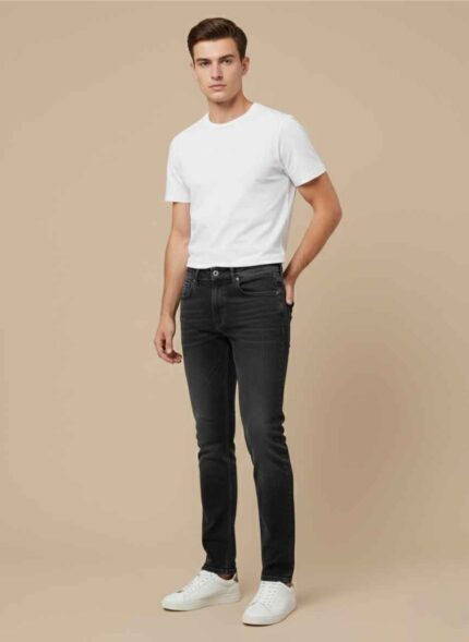 Front view of Gelani's dark gray jeans for men on a light brown background. Close-up of the premium stitched pockets and denim texture of men's jeans. Stylish dark gray winter denim trousers for men in size 30 to 40. Gelani's brand label on the waistband of high-quality jeans for men. Full-length view of stitched dark gray jeans for the Pakistani winter season. jeans for men