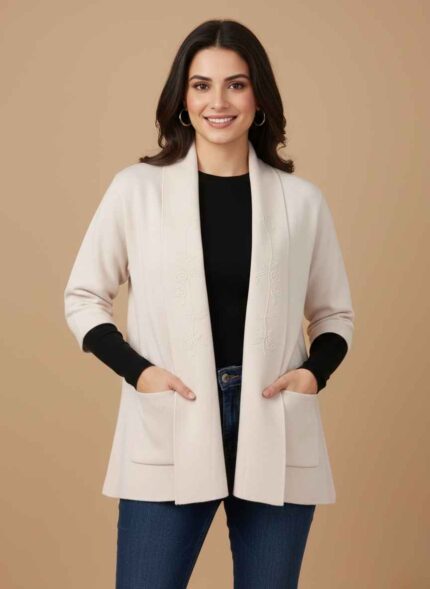 Women's skin-colored lamb wool sweater with floral embroidery Black stitched winter cardigan for women by Gelani's Close-up of white lamb wool sweater showing front pockets Light pink embroidered wool sweater for women Pakistan winter Gelani's free size lamb wool sweater in off-white front view