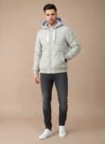 Close-up of a light green or sage-colored men's Quilted Bomber Jacket with a grey hooded insert, front zipper closure, and diamond pattern quilting.