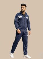 Navy blue Puma Men's Tracksuit with a white chest panel on the full-zip jacket and matching athletic pants. High-quality performance sportswear.