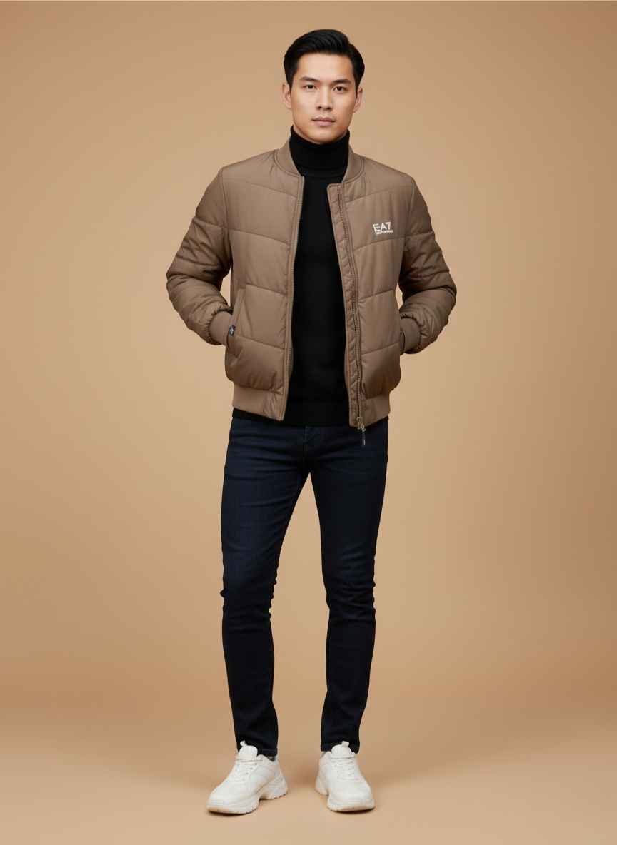 Brown quilted parachute jacket for men by Gelani's front view Men's winter stitched parachute jacket in earthy brown tone Close up of zipper and stitching on a parachute puffer jacket Full sleeve ribbed cuff detail on men's parachute outerwear Gelani's branded winter jacket for men available in large sizes parachute jacket for men