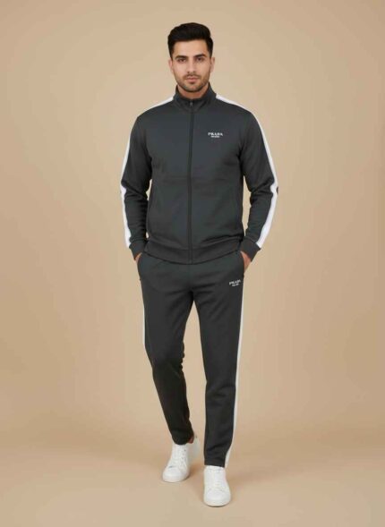 Main Image: Front view of Gelani’s black Tracksuit for Men featuring white shoulder stripes and Prada branding. Detail Shot: Close-up of the dry-fit fabric texture and high-quality stitching on the tracksuit jacket. Logo Detail: Metallic silver Prada Milano logo on the chest of the black winter tracksuit. Full Set: Two-piece black winter tracksuit for men including jacket and matching trousers. Cuff Detail: Ribbed cuffs and hem detail of the Gelani’s men's athletic winter wear. Tracksuit for Men