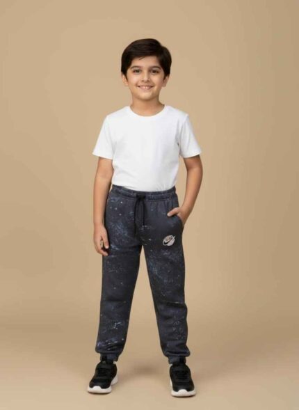 Men navy blue fleece joggers with white spatter print pattern.Close up of Adidas trefoil logo on navy blue winter trousers.Elastic waistband and black drawstring detail on men's joggers.Full view of navy blue jogger pants for winter fashion Pakistan.Ribbed ankle cuffs on men's navy blue athletic sweatpants.Men Navy Blue Winter Joggers Pakistan