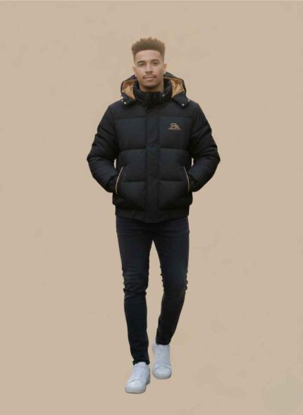 Main View: Gelani's black parachute jacket for men featuring a hooded puffer design and tan piping. Detail View: Close-up of the tan accent piping and side pocket detail on the men's black parachute jacket. Interior View: Black winter puffer jacket showing the contrasting tan hood lining and interior fabric. Hood Detail: Detachable insulated hood with snap-button closures on the men's winter parachute coat. Cuff & Hem: Reinforced elasticated cuffs and hem on the stitched parachute jacket for men. parachute jacket for men