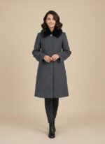 Product photo of a relaxed-fit beige V-neck knit coat with a chunky texture, four brown buttons, and two patch pockets.