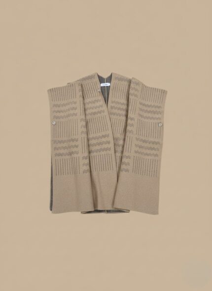 Beige women sweater shawl worn over black dress, sleeveless knit wrap for winter layering.