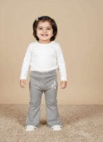 Flat lay view of brown ribbed knit baby pants with a small white animal graphic on the lower right leg and cuffed ankles.