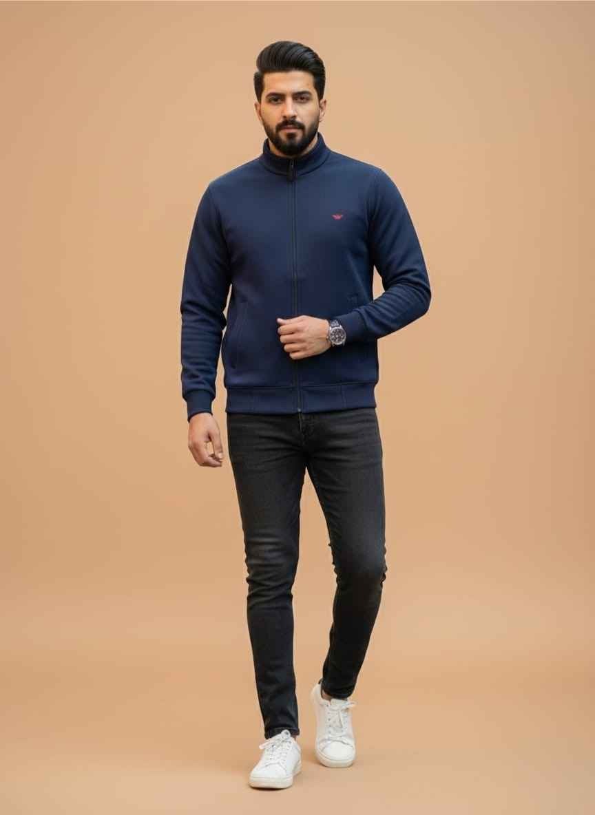 Navy blue wool jacket for men with front zipper and red logo. Gelani's brand stitched wool jacket for winter in Pakistan. Front view of a minimalist navy blue men's wool jacket. High-neck wool jacket for men in navy blue color with ribbed cuffs. Premium winter outerwear for men featuring soft wool material. wool jacket for men