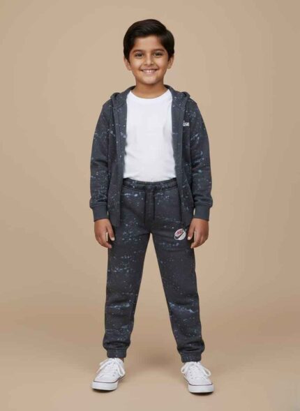 Kids-blue-terry-winter-trousers-galaxy-printDark-blue-kids-joggers-with-white-splatter-designClose-up-of-terry-fabric-and-Kids-winter-wear-trousers-with-ankle-cuffs-detail Side-profile-of-blue-printed-trousers-for-kidsKids Blue Terry Winter Trousers in Pakistan