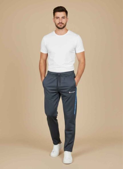 Front view of dark gray champion track pant for men on a neutral background. Close-up of the stitched jersey fabric and side-stripe detail on men's joggers. Men's winter athletic trousers in navy blue with elasticated waistband. Detailed shot of the zipper pocket and brand logo on jersey track pants. Black champion track pant for men showing the tapered leg and cuffed ankle. champion track pant for men