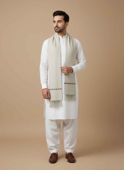 Gelani's off-white whool shawl for men with traditional patterned border Close up of stitched wool fabric texture for men's winter shawl Men's black wool shawl folded neatly for winter collection Pakistan Traditional Pakistani men's shawl in tea pink with detailed embroidery Premium wool winter wrap for men by Gelani's brand whool shawal for men